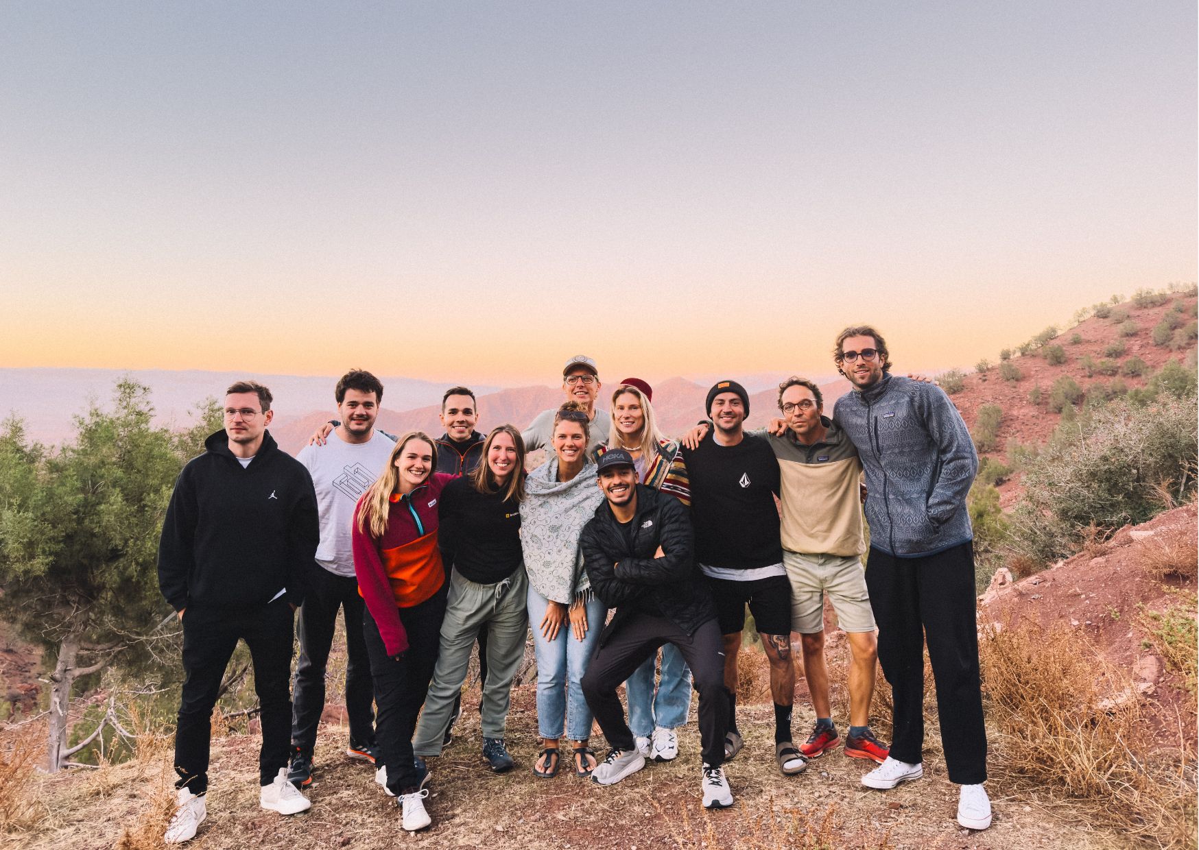 The Bookinglayer team with a sunset in the background.
