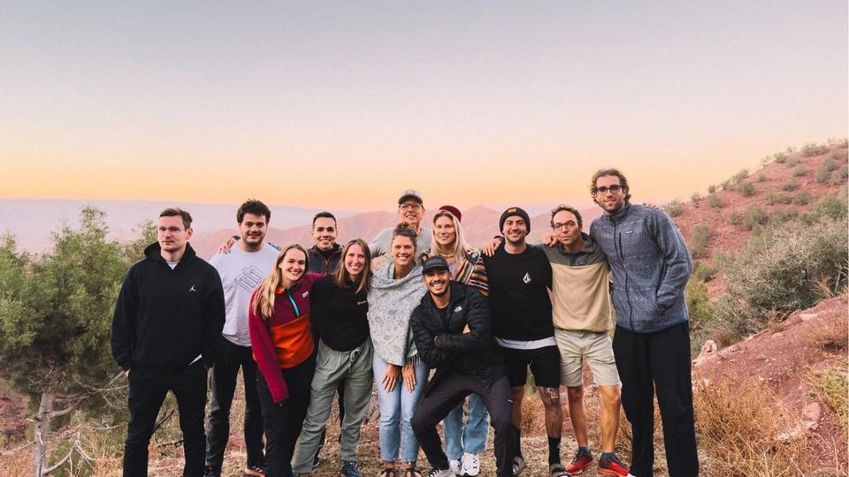 The Bookinglayer team with a sunset in the background.