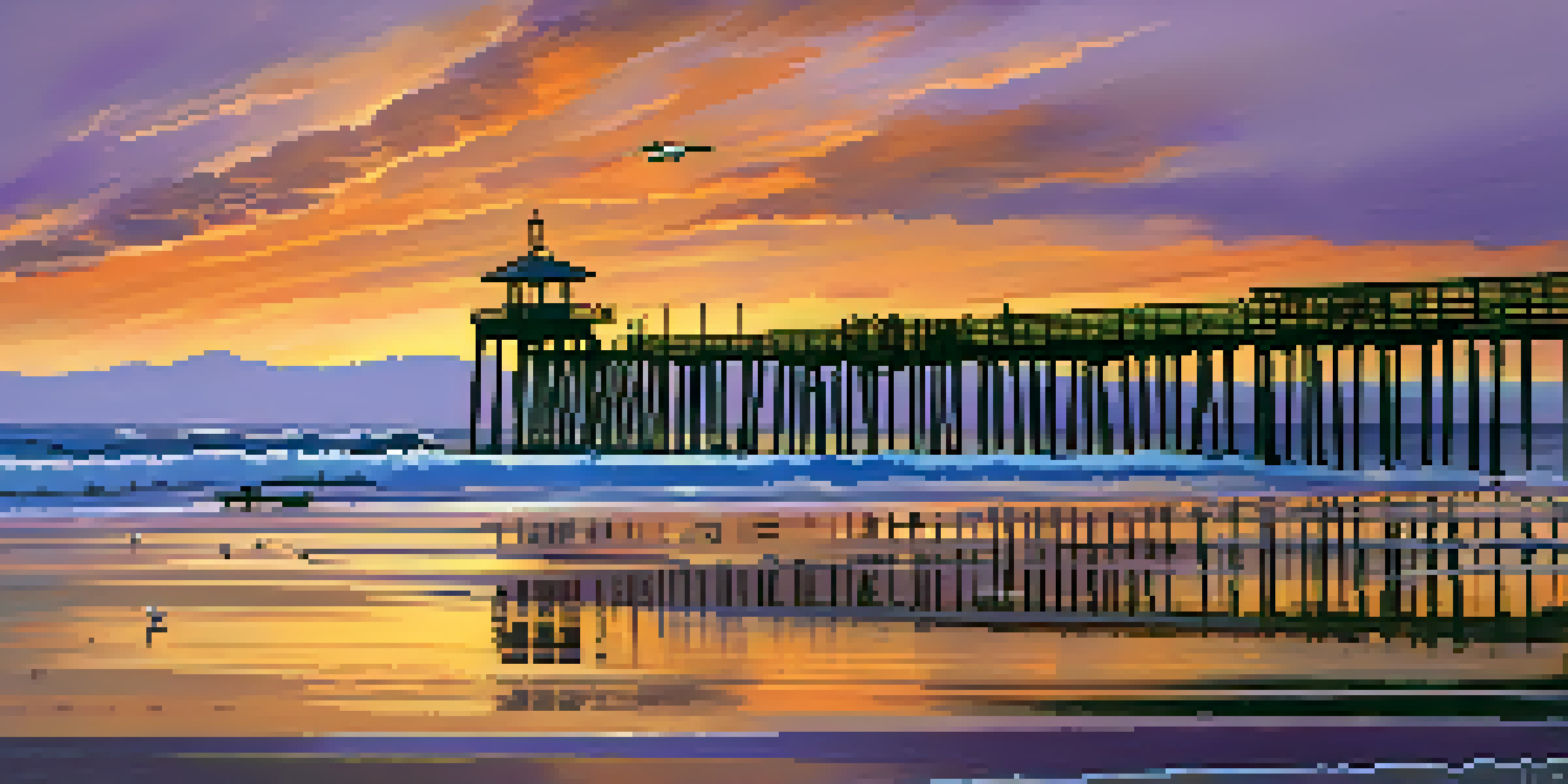A scenic sunset view of the historic Malibu Pier with colorful skies and gentle waves.
