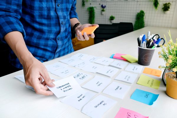 Man arranging post it notes into different topics