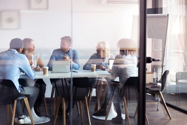 Glass office with a meeting happening inside