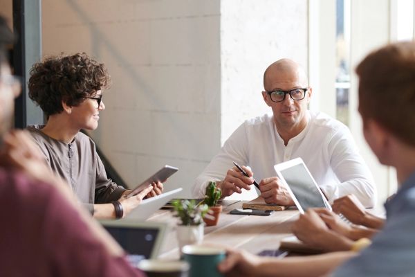 Group of people talking around a table