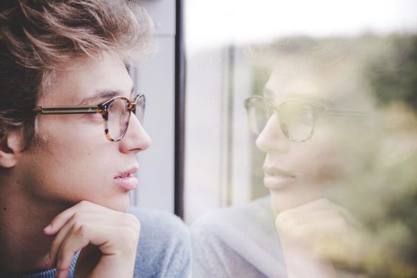 Man looking contemplative out a window