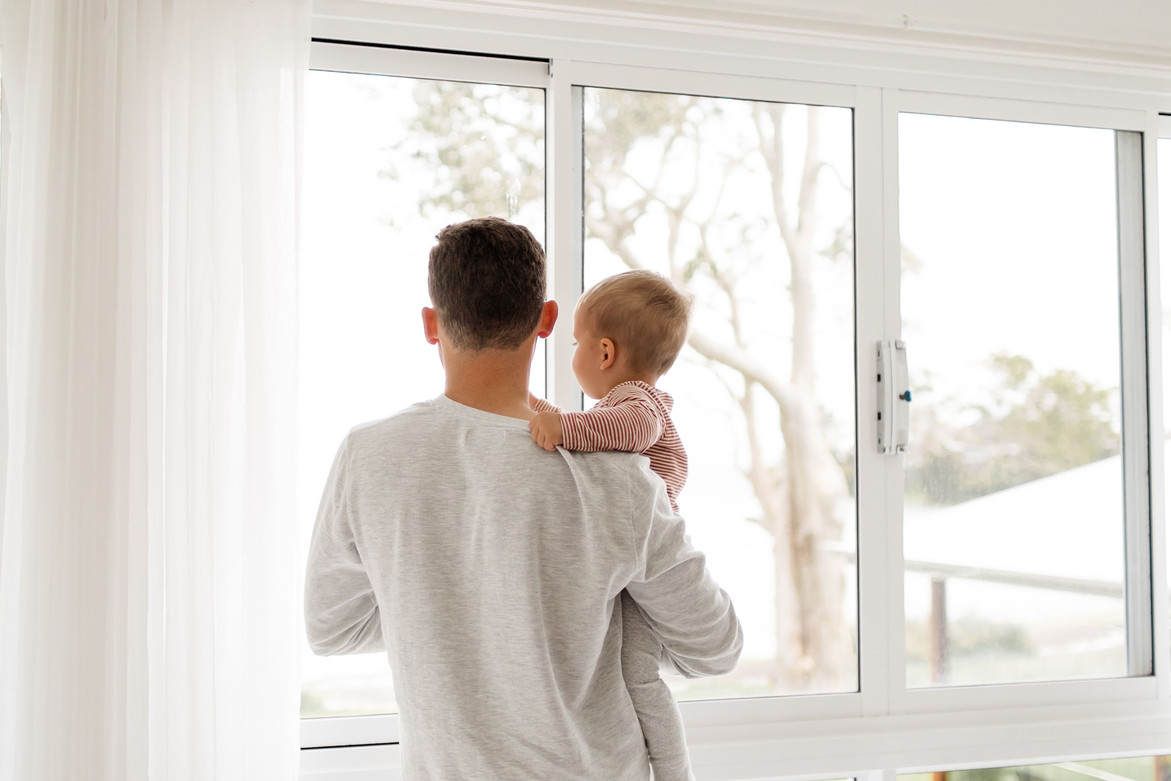 Father and Child looking out of a window