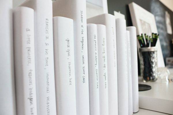 Row of white books all lined up neatly beside each other
