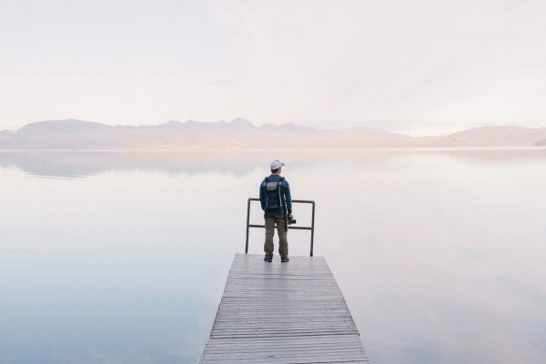 Man thoughtfully looking out over a scenic scenery 