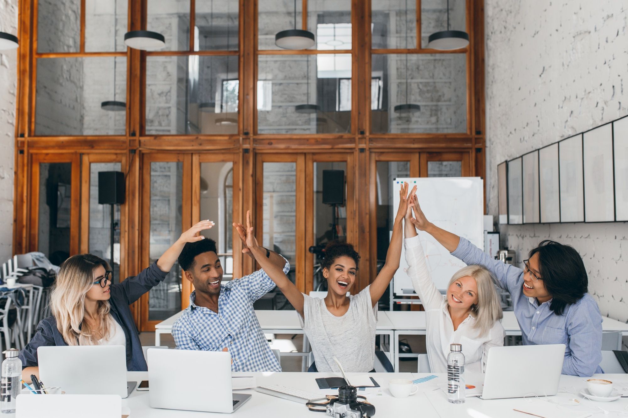 Group of people raising their hands