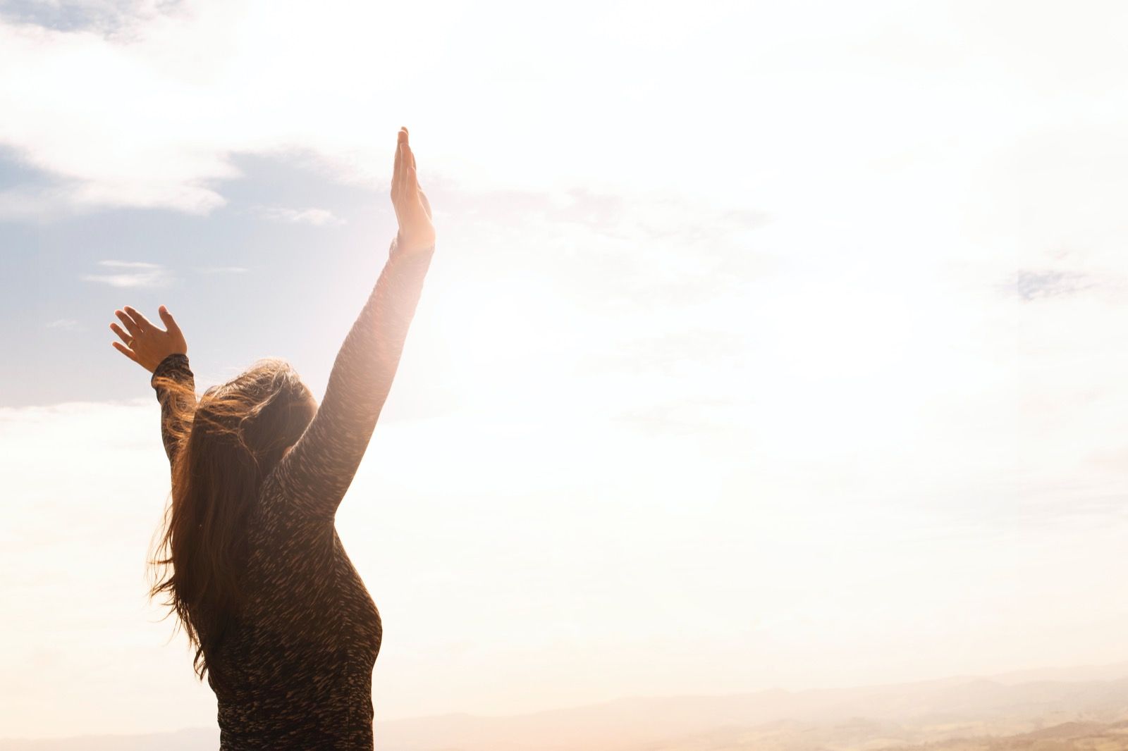 Person holding hands in the air