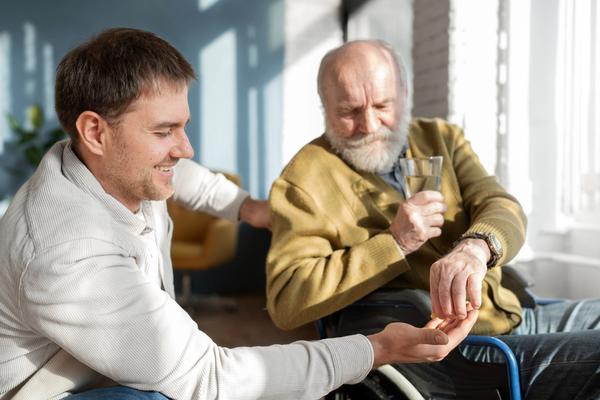 old patient on wheelchair take a meds