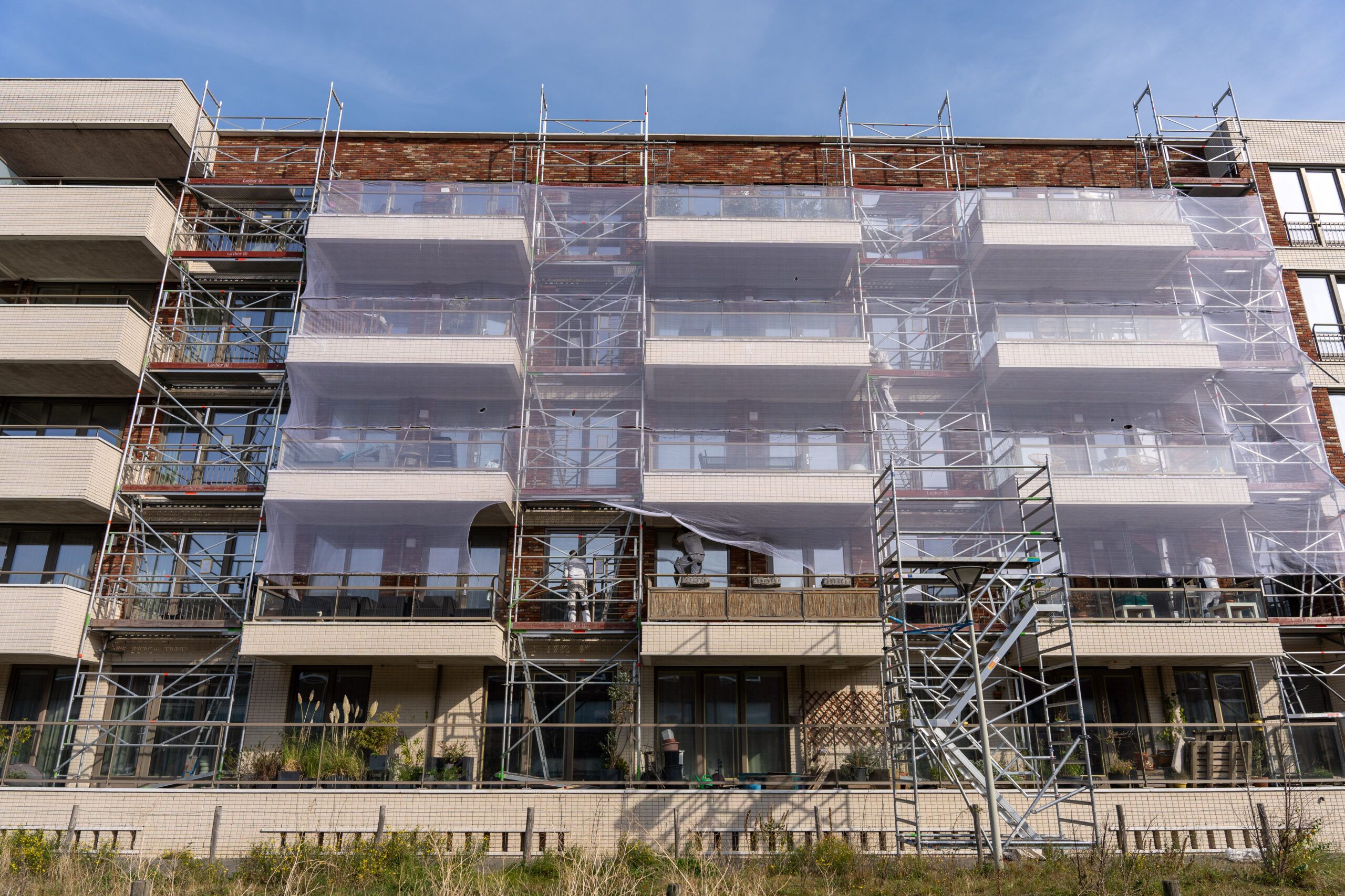 Steigers met doek langs de balkons van het complex aan de Houtrustweg in Scheveningen