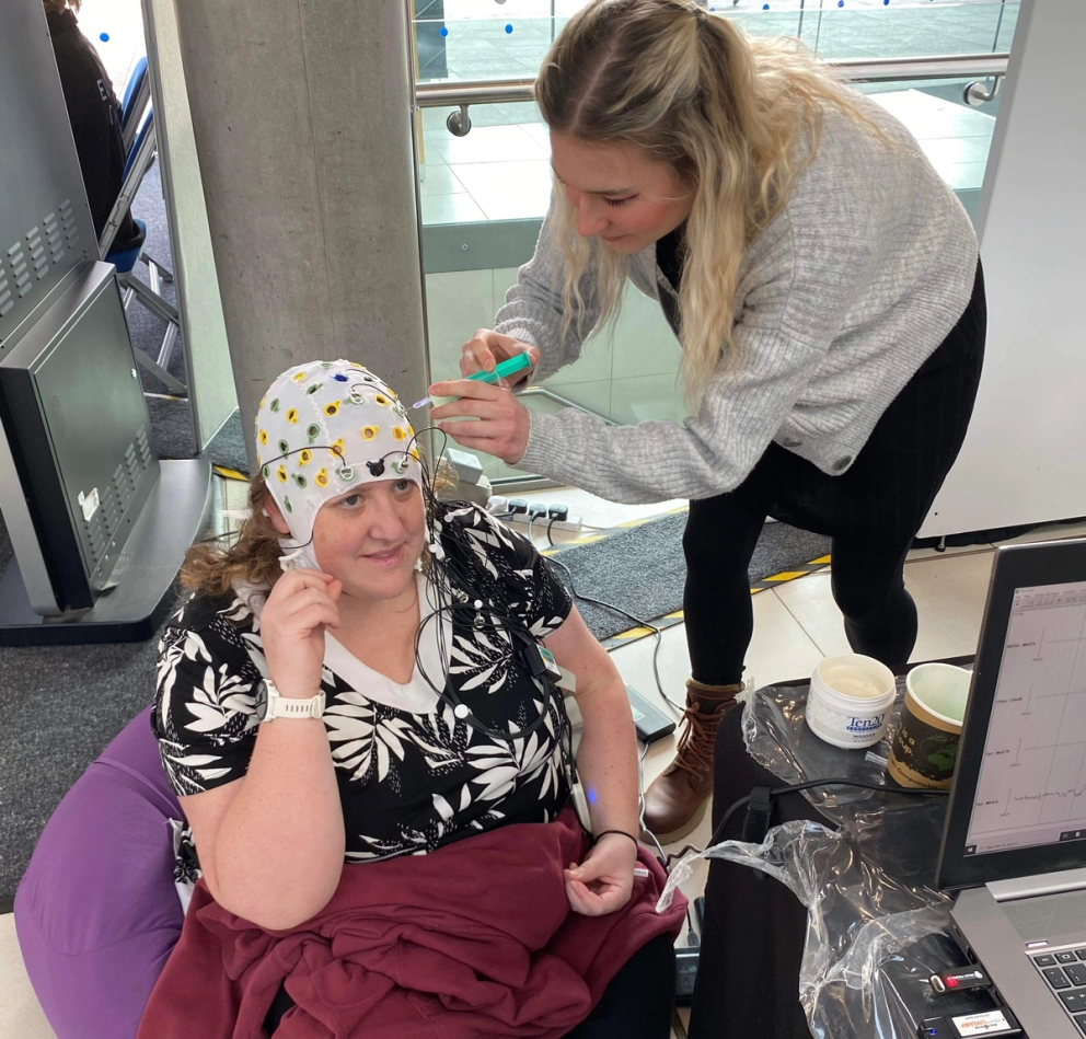 SINEA team member Dr Jo Bower wearing a electroencephalogram (EEG) cap.