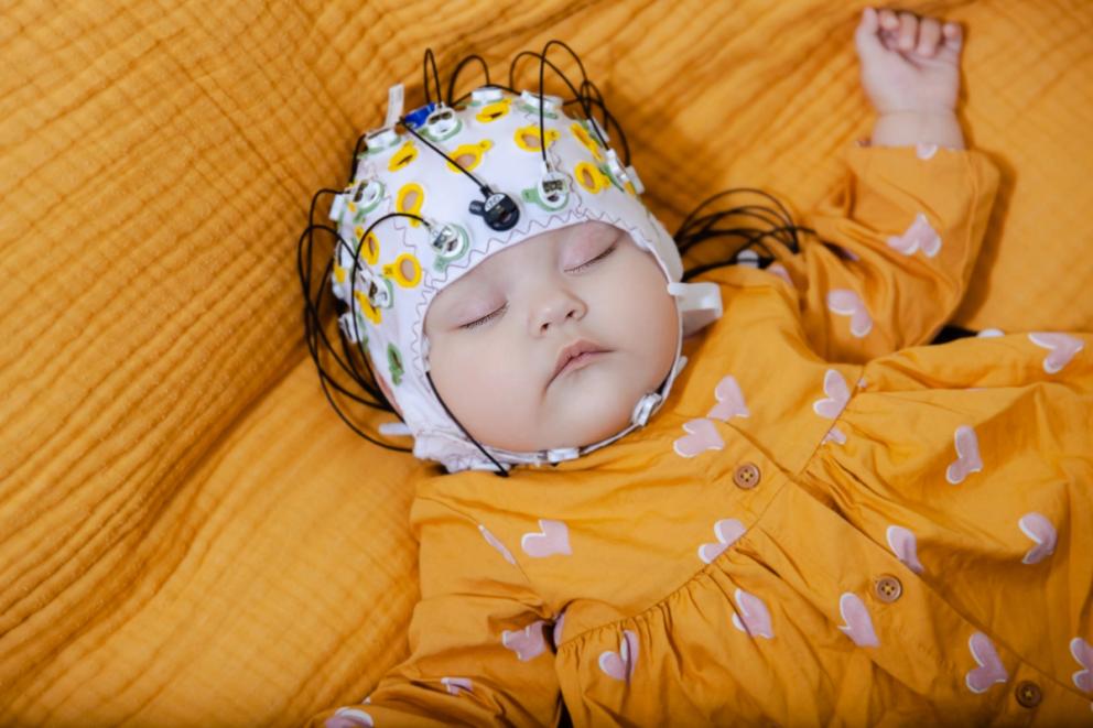 Baby asleep in EEG cap