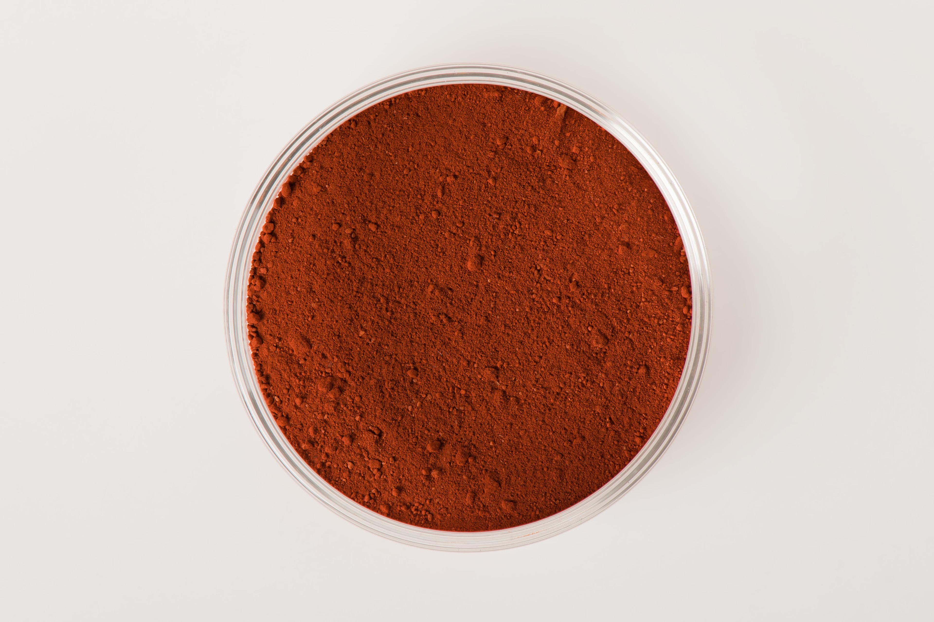 A sample of red ochre pigment in a petri dish