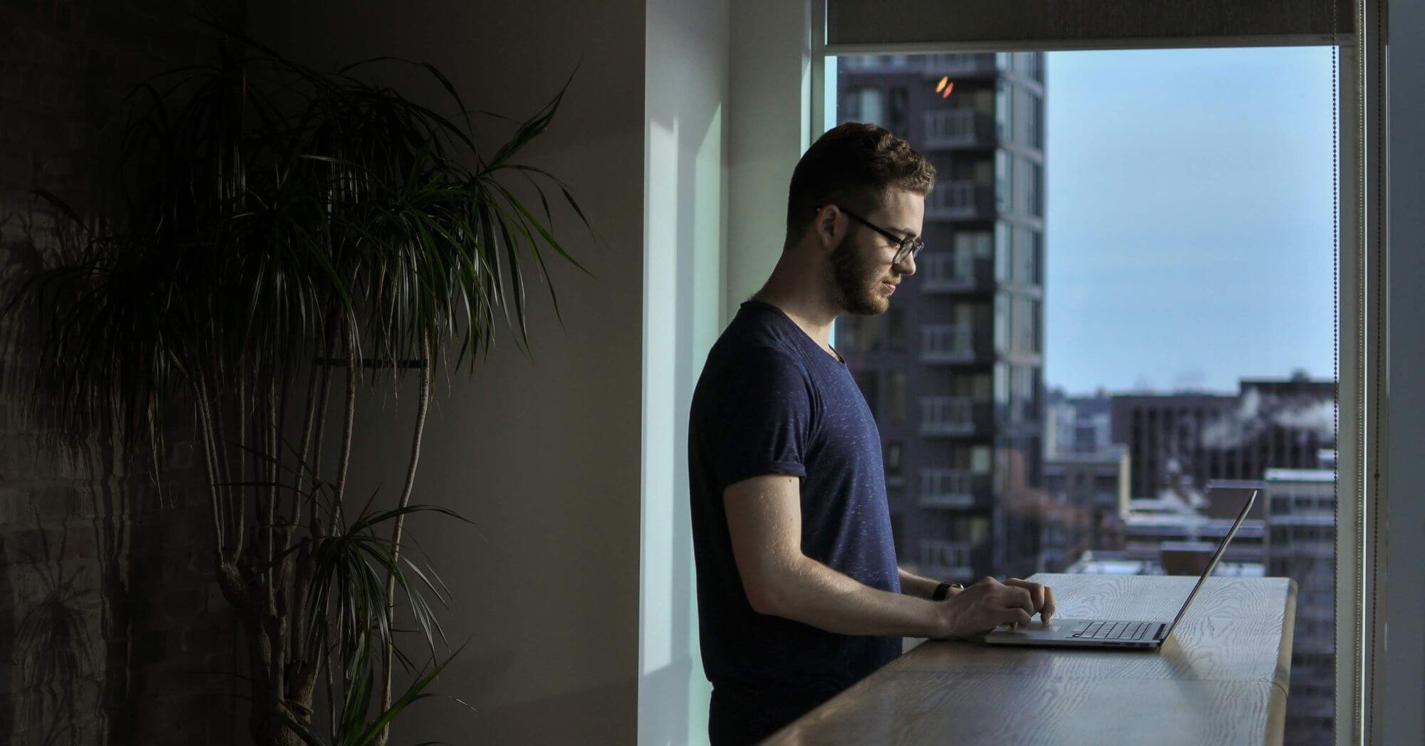 A man with a laptop in a beautiful apartment