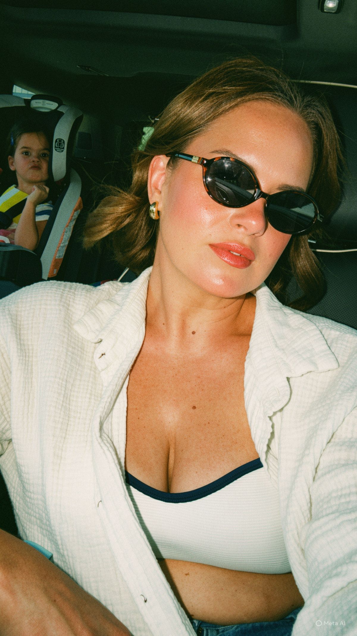 Candace in the car with sunglasses on