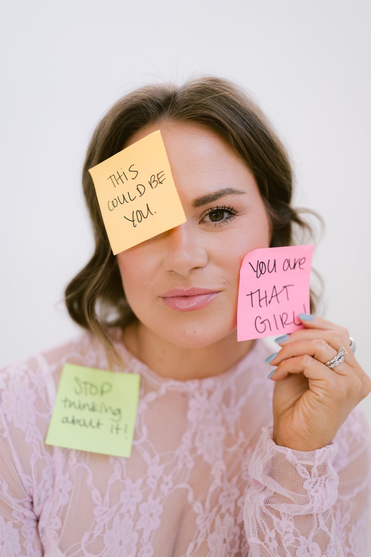 Candace holding sticky notes reading "this could be you" and "you are THAT girl" up to her face