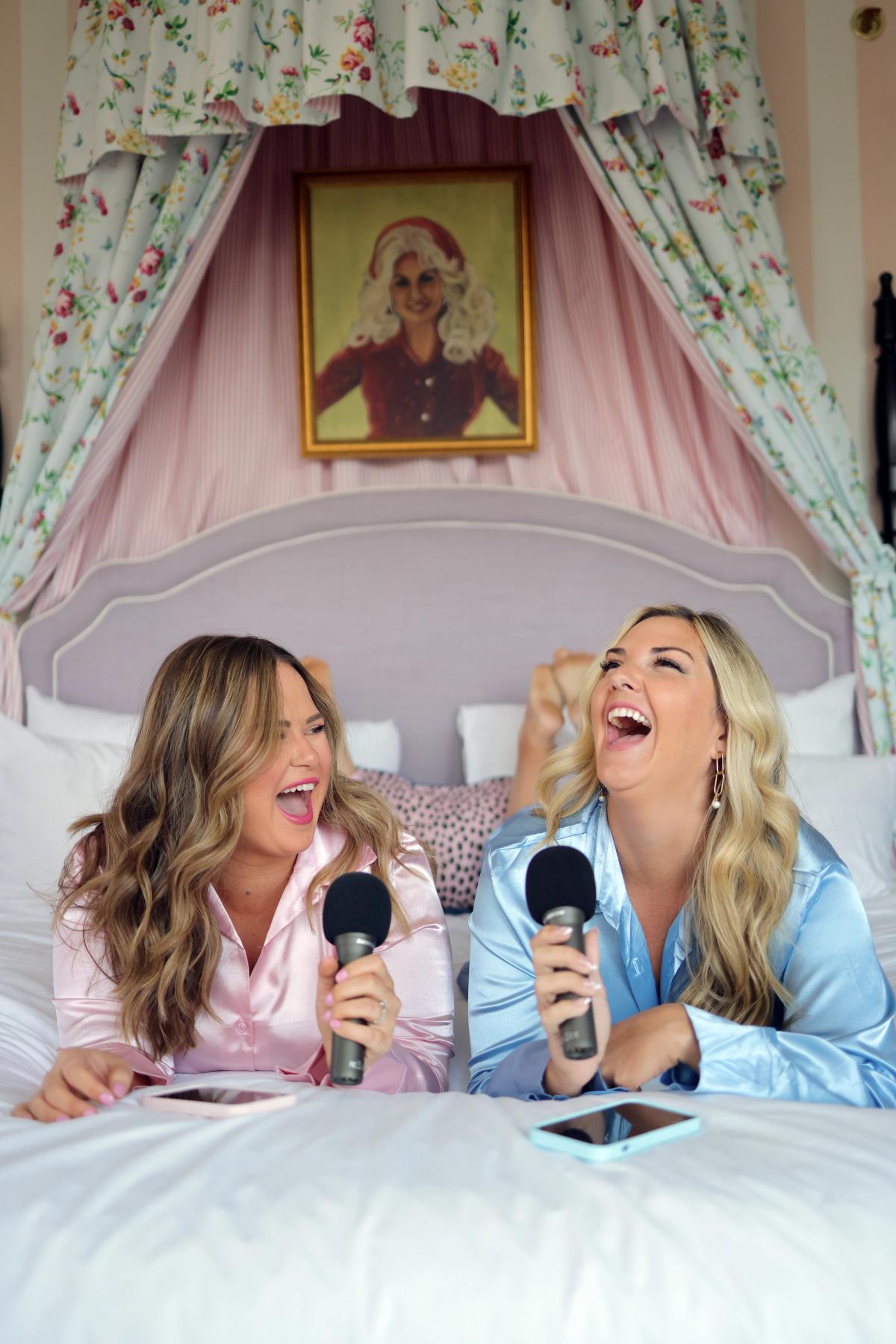 Candace and Whitney on bed with microphones