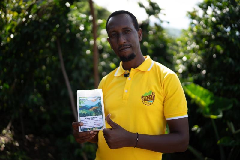Aimé inspects his coffee cherries