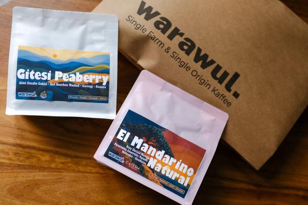 Brown mailing envelope with warawul logo and 2 bags of roasted coffee