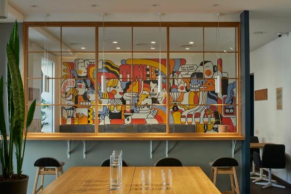 Interior of the Kavos Reikalai café with mural