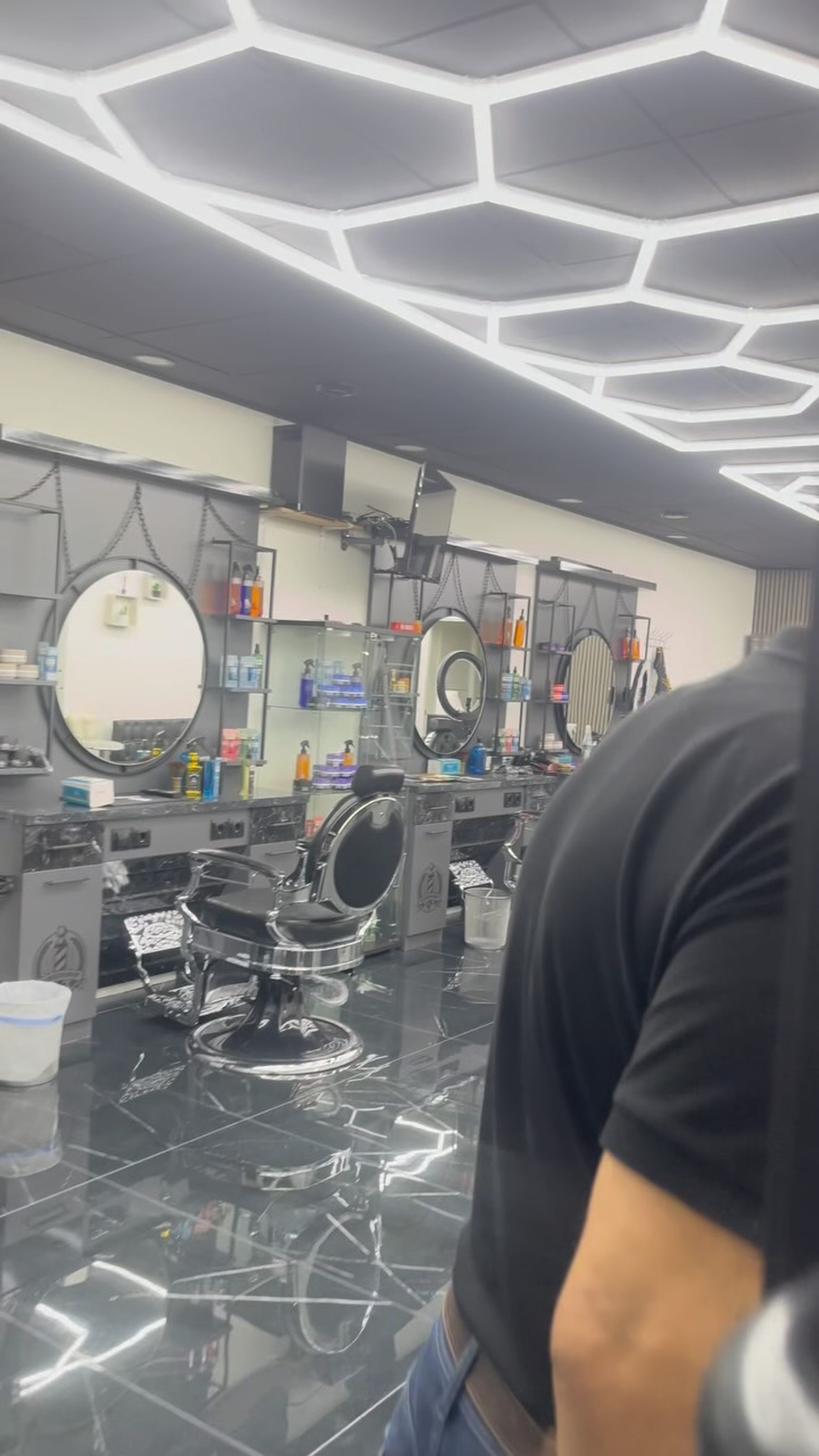 Interior de la barbería con los neones del techo encendidos
