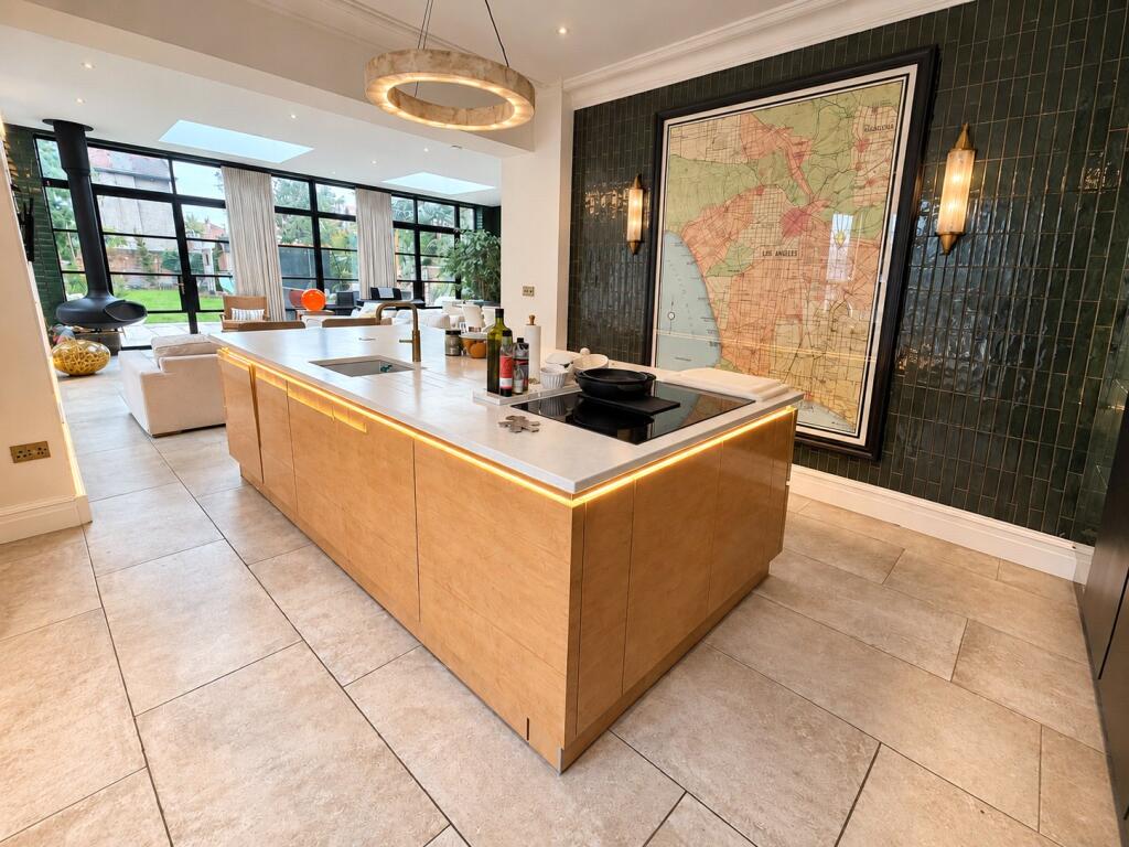 Kitchen island with the steel-look glazed wall and garden beyond