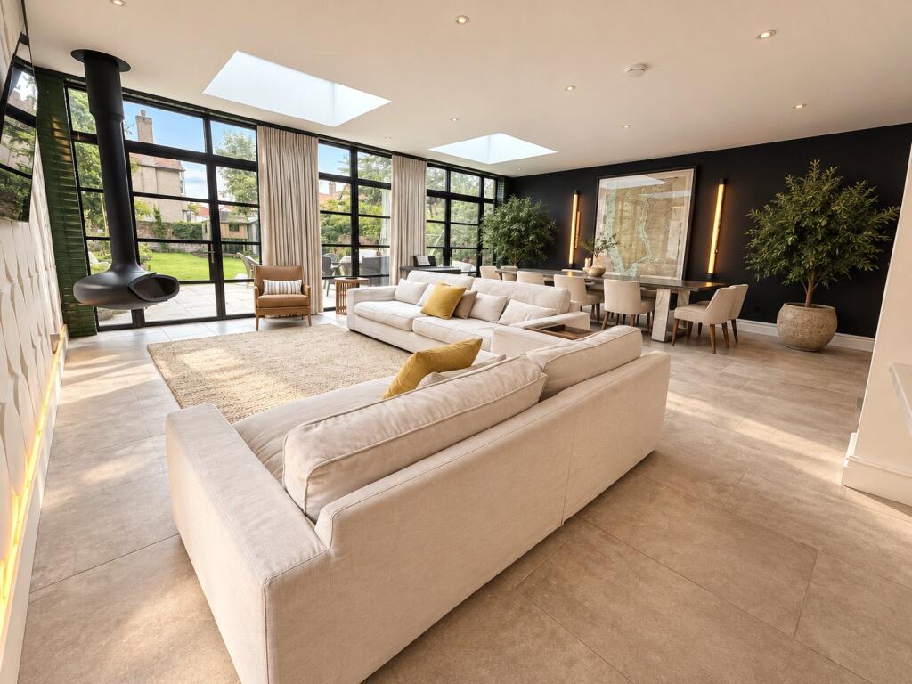 Living space looking out through full-height steel-look aluminium doors to the garden