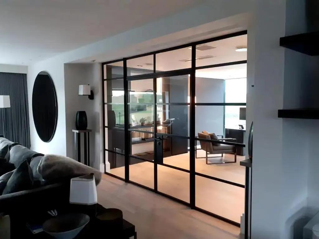 Internal glazed steel doors dividing two living spaces