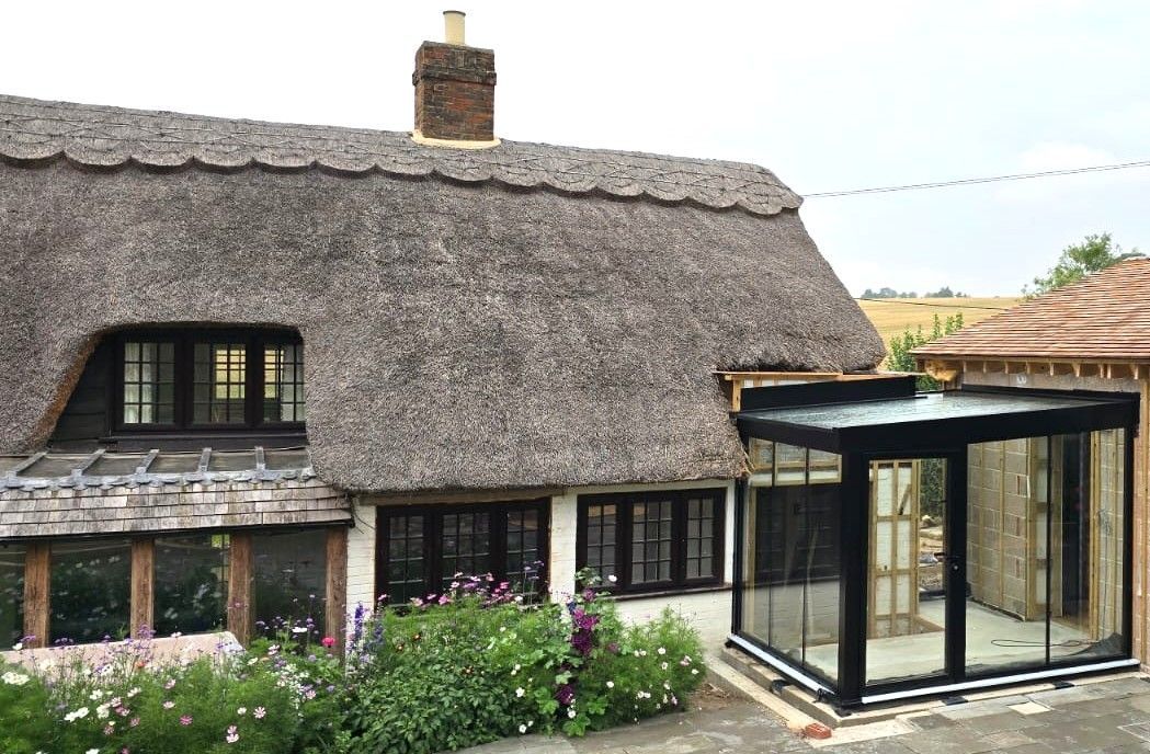 minimal Glass Box Extension on traditional building