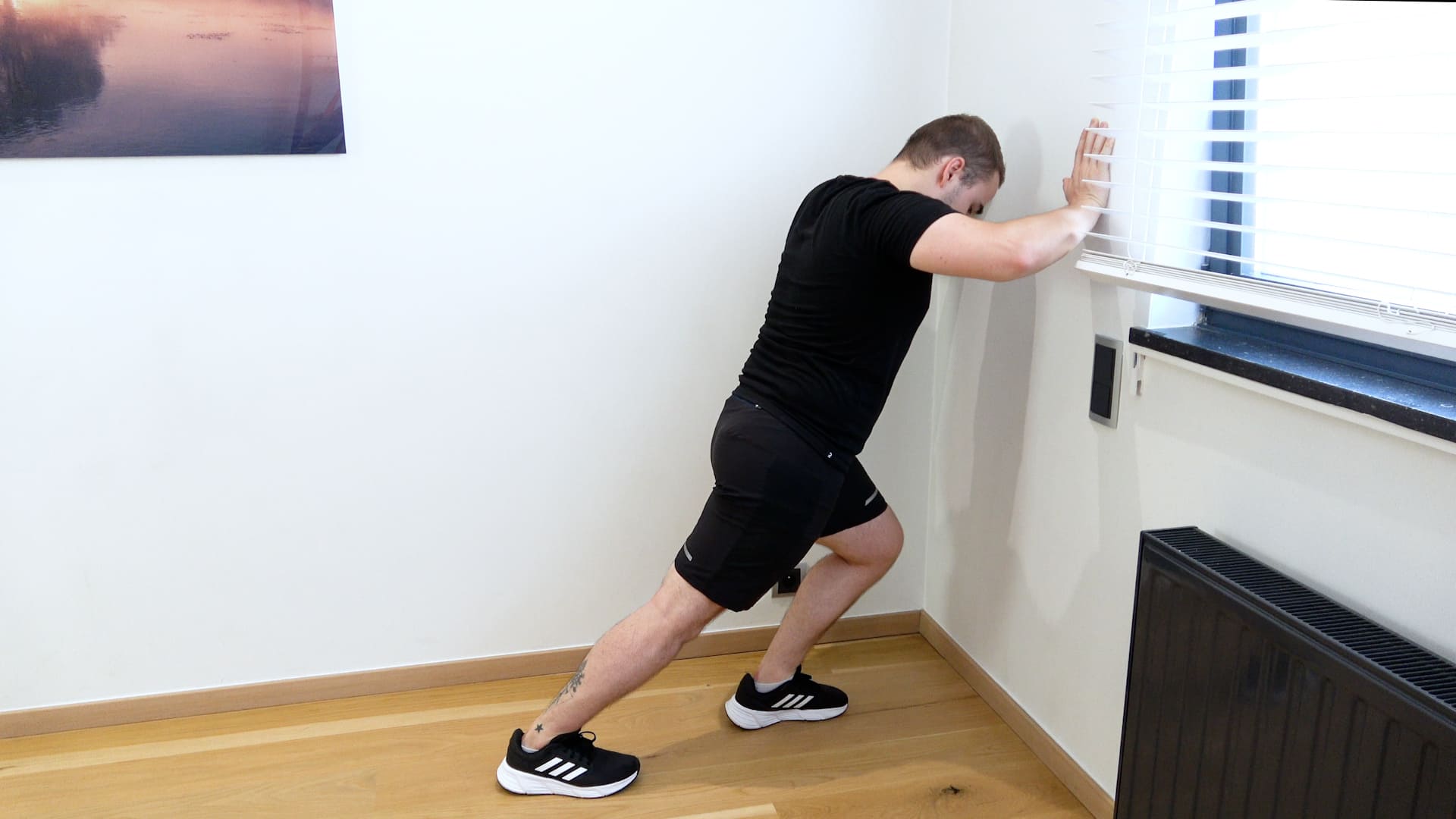 Étirement du triceps sural en fente contre le mur, vue 2
