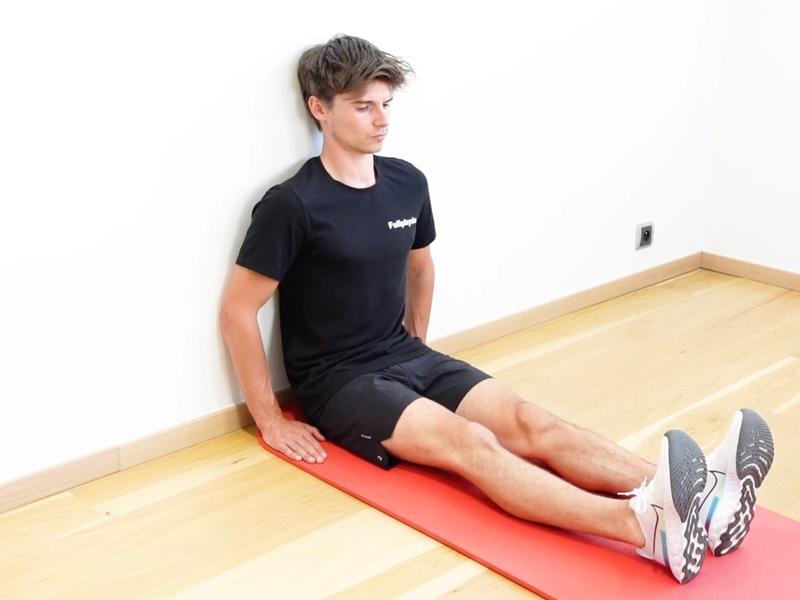 Hip Flexor Strengthening Seated Against a Wall, view 1