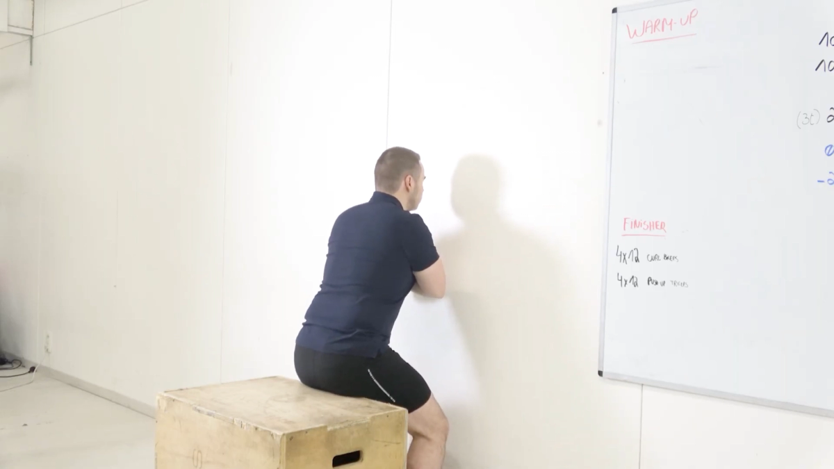 Squat face au mur (faible amplitude)