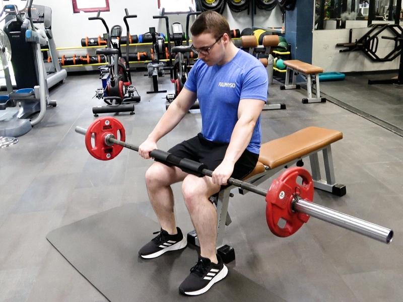 Seated Heel Raises With Barbell, view 1