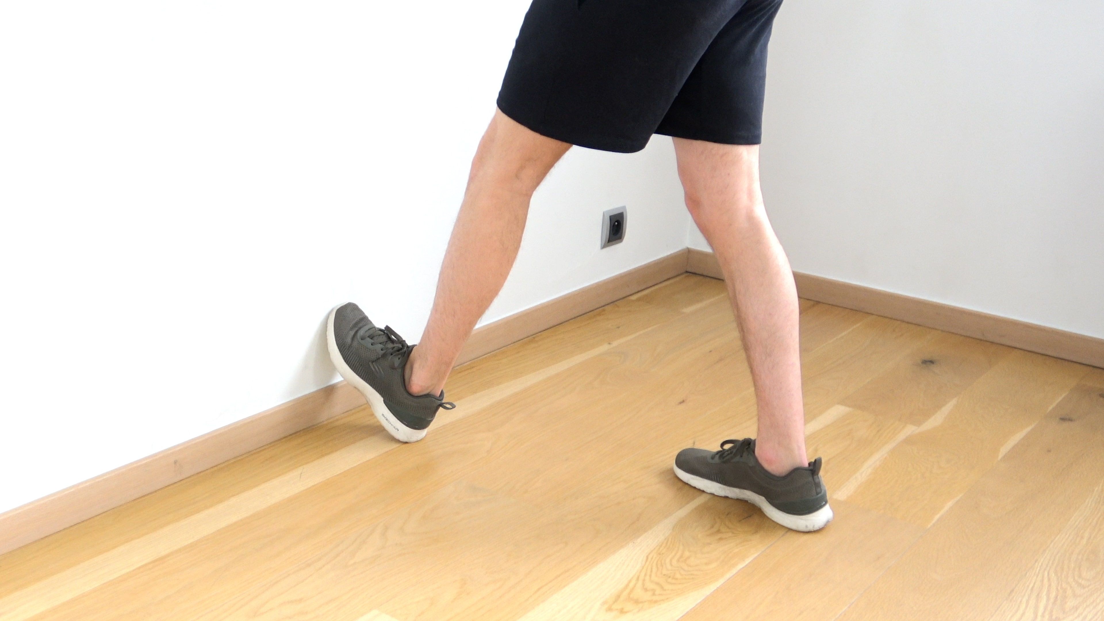 Calf Stretch With Toes Against Wall, view 1