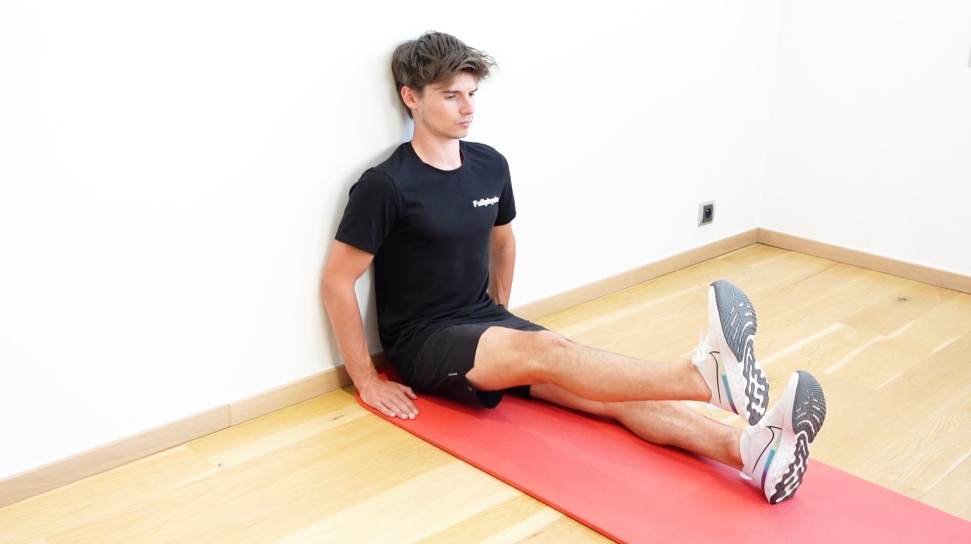 Hip Flexor Strengthening Seated Against a Wall, view 2