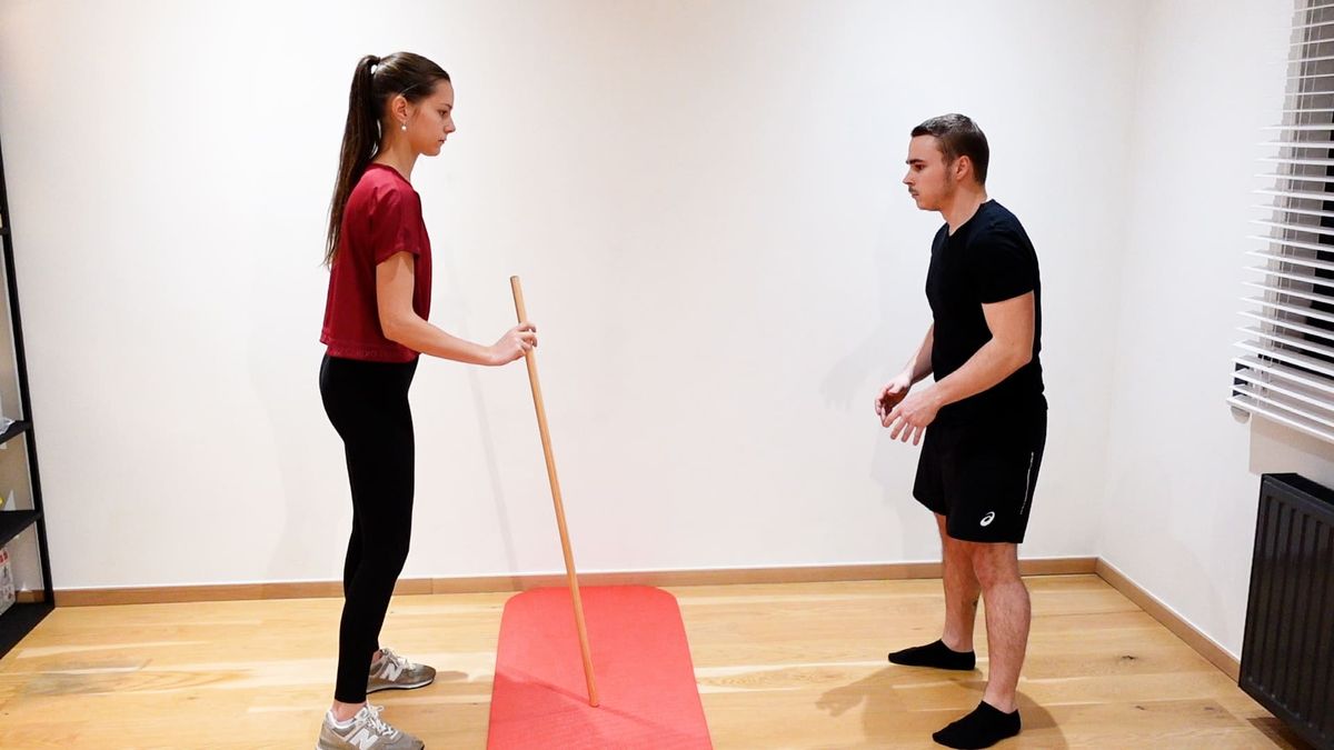 Réception bâton jambes tendues