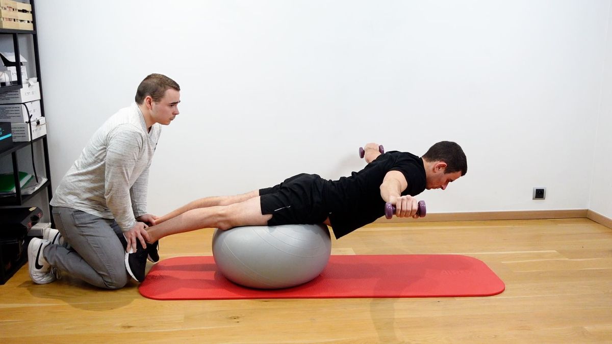 Superman on Swiss Ball With Weights