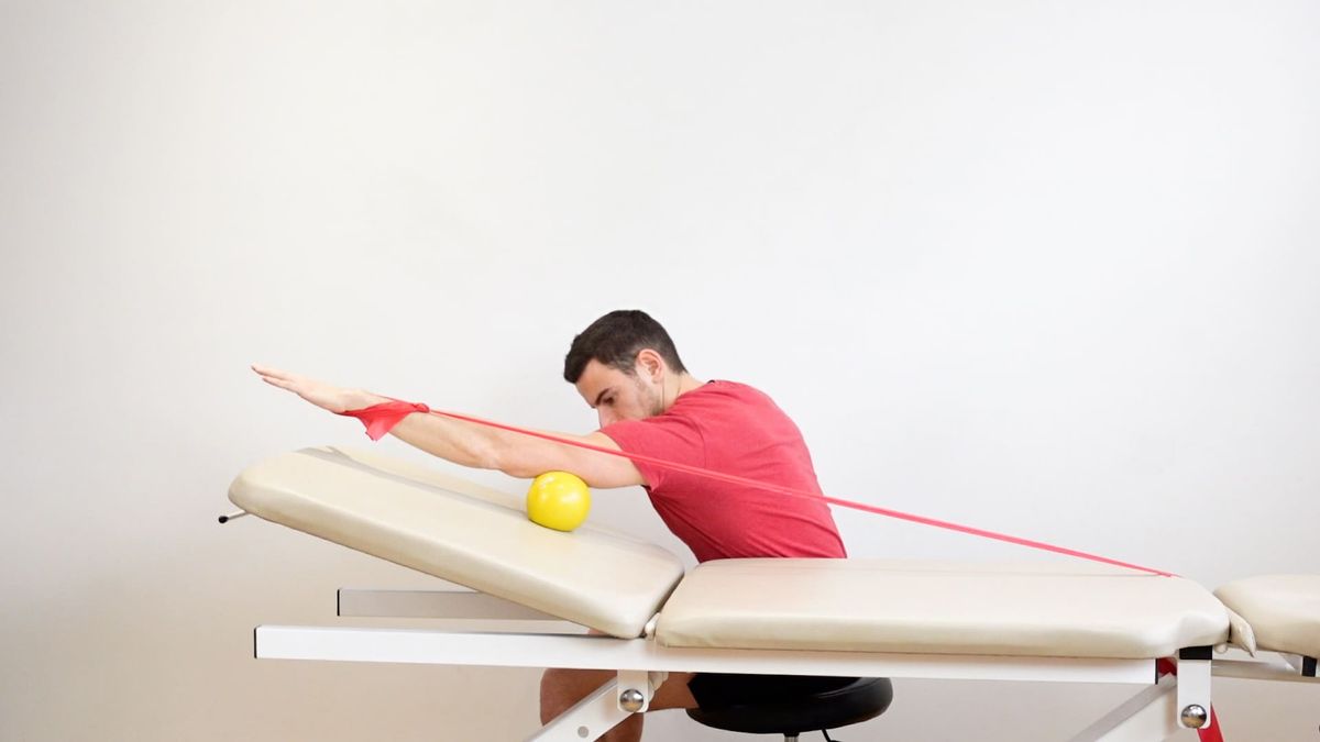 Shoulder Flexion on Ball With Elastic Band on Inclined Plane