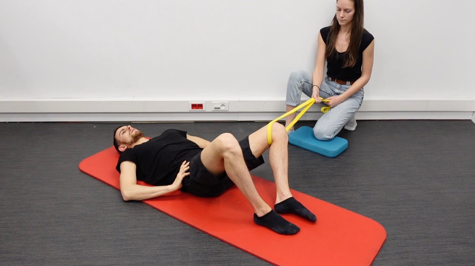 Hip Adduction Strengthening Supine With an Elastic Band, view 1