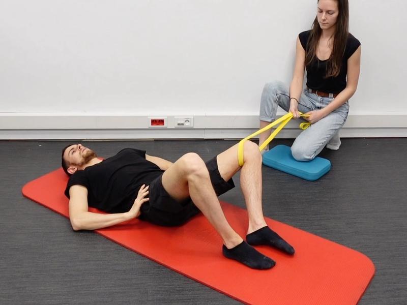 Hip Adduction Strengthening Supine With an Elastic Band, view 1