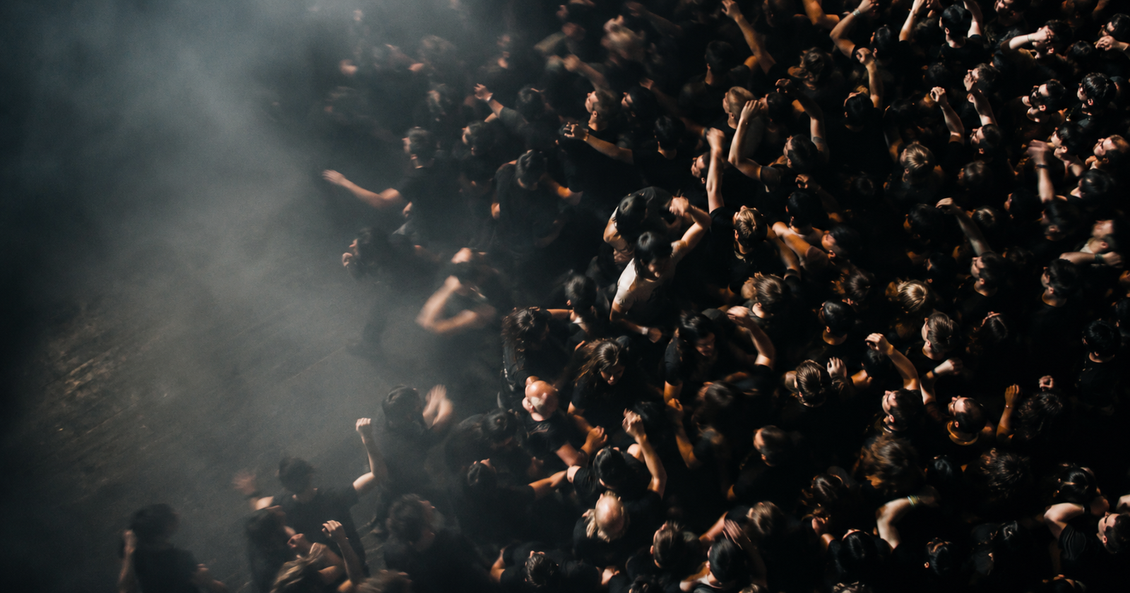 A blurred crowd moving in a pit seen from above