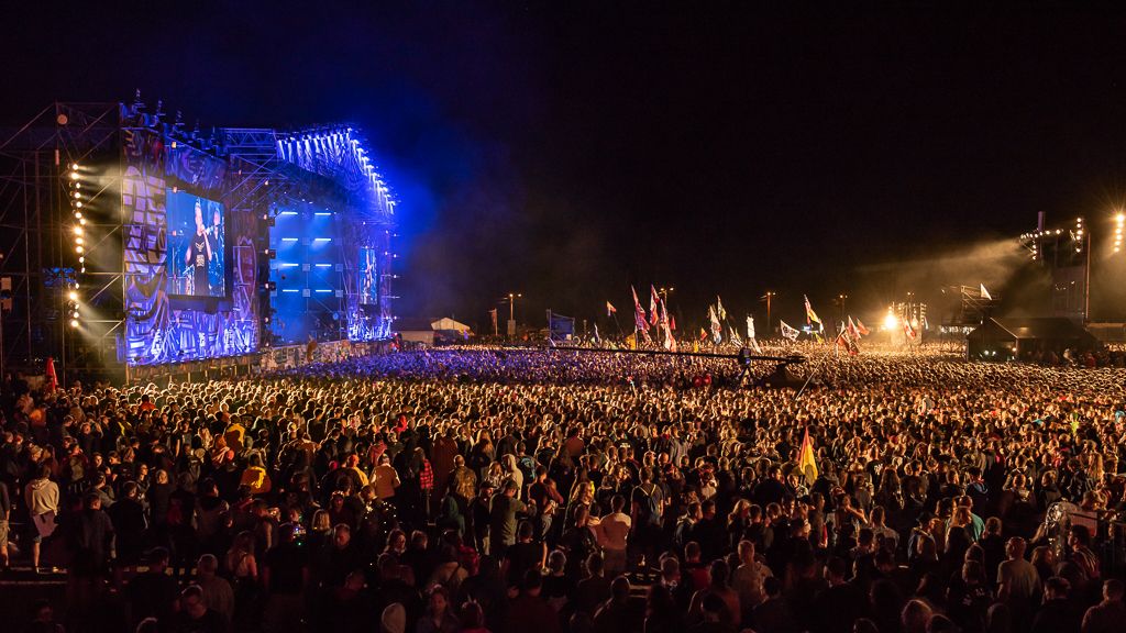 Crowd at a large outdoor rock festival main stage