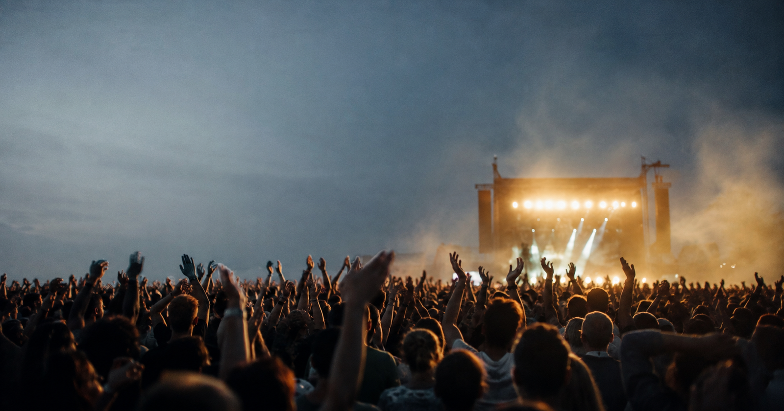 a crowd of hands raised