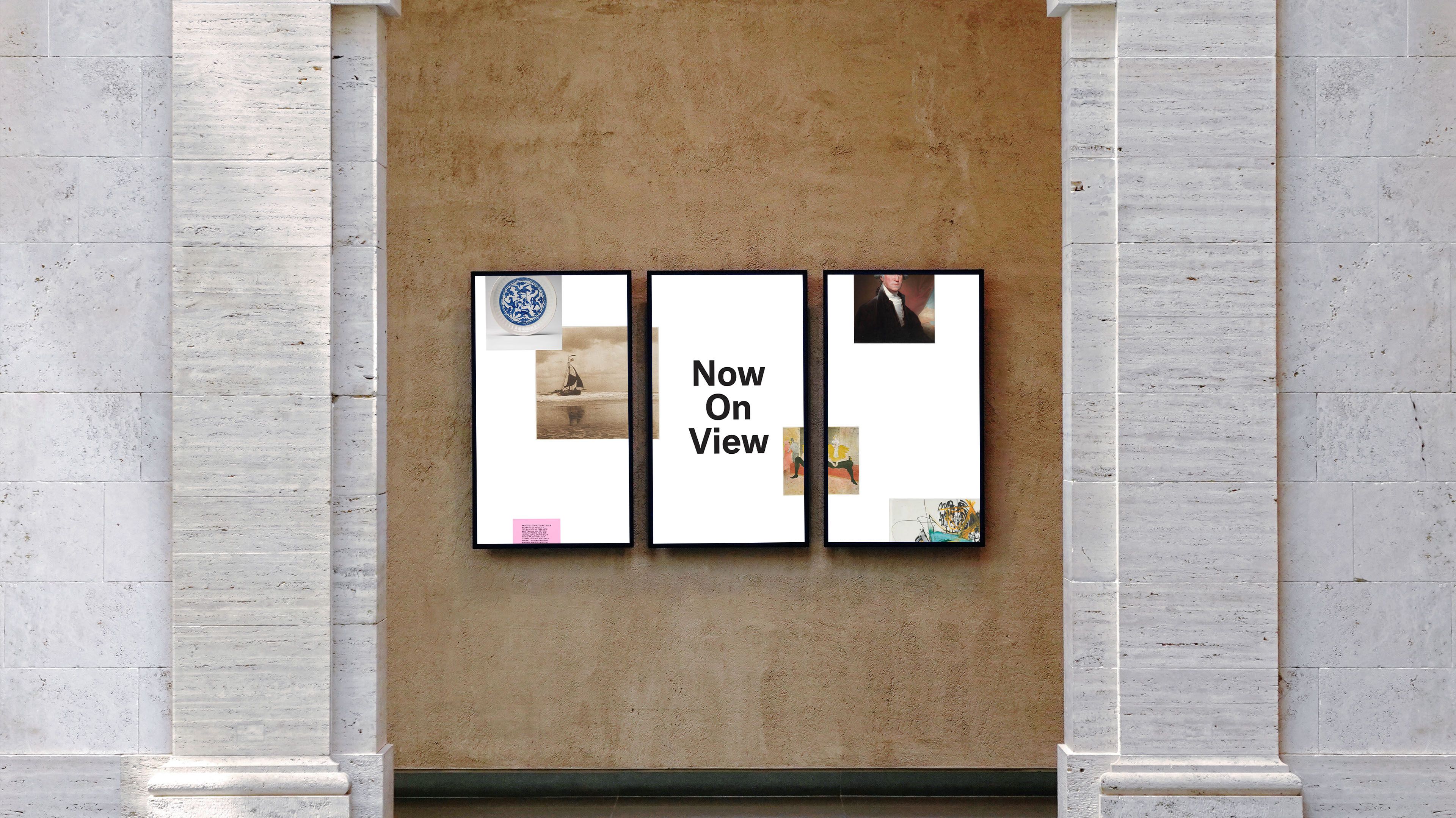 Three digital display screens in stone museum alcove reading "Now On View" with artwork thumbnail collage
