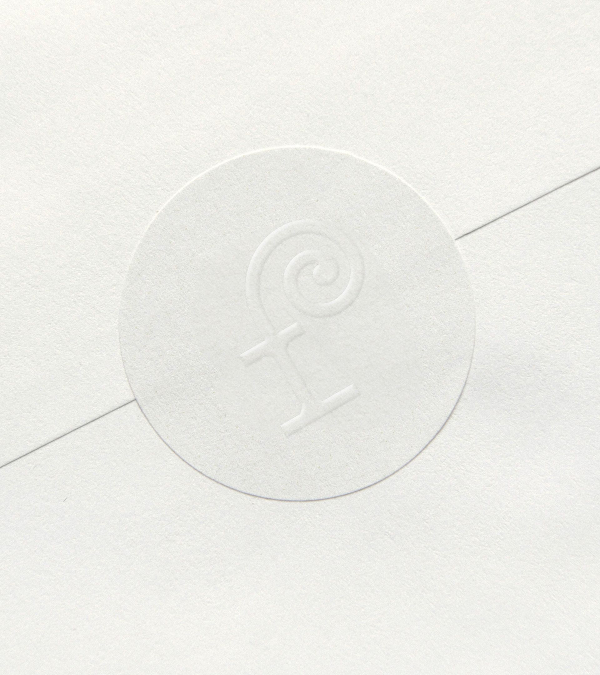 Forage envelope seal: "f" logo debossed in circular wax-seal style on white cotton envelope — letterpress detail