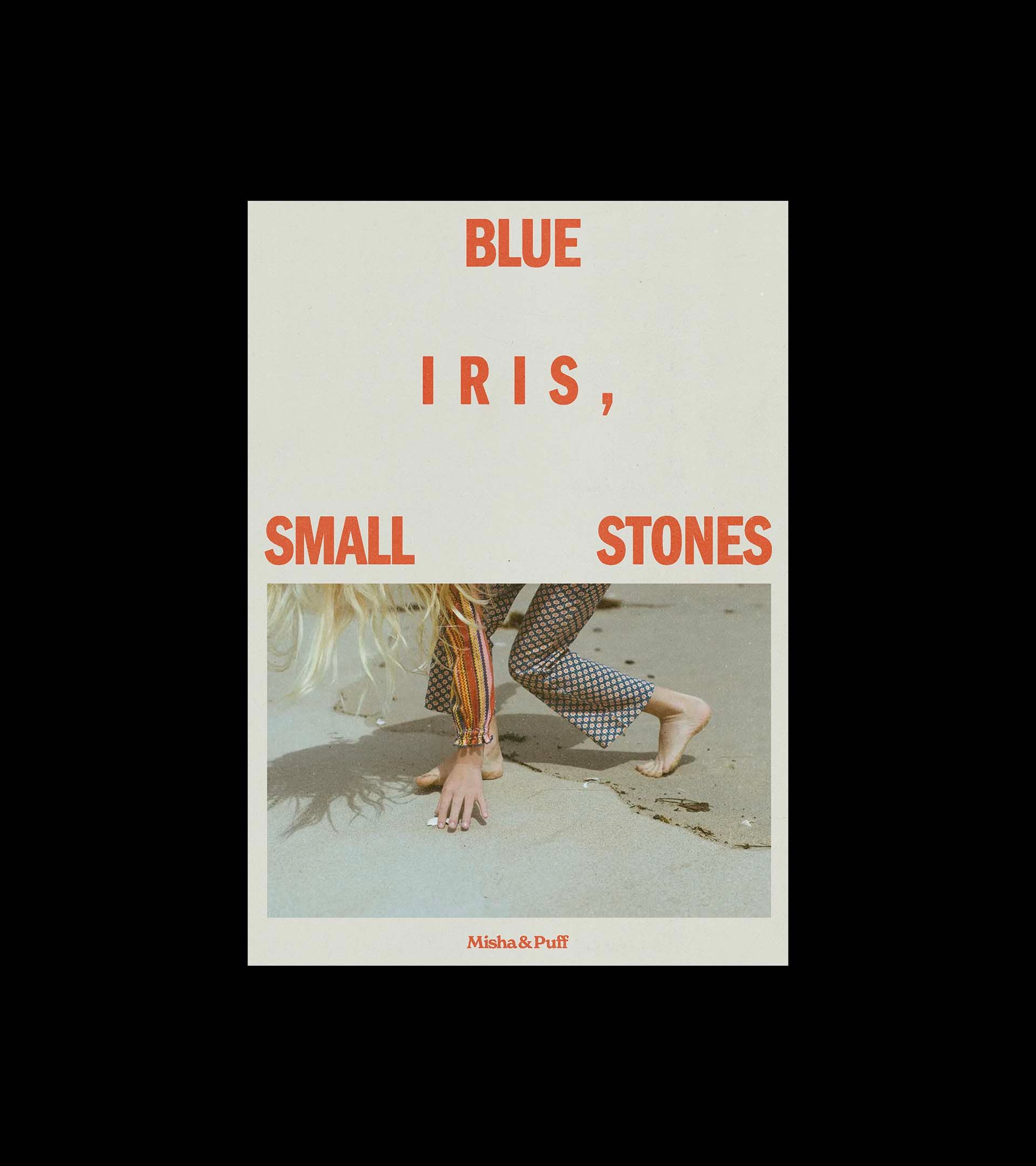 Misha & Puff "Blue Iris, Small Stones" cover, cream with terracotta type and a full-bleed photo of a child on sand.