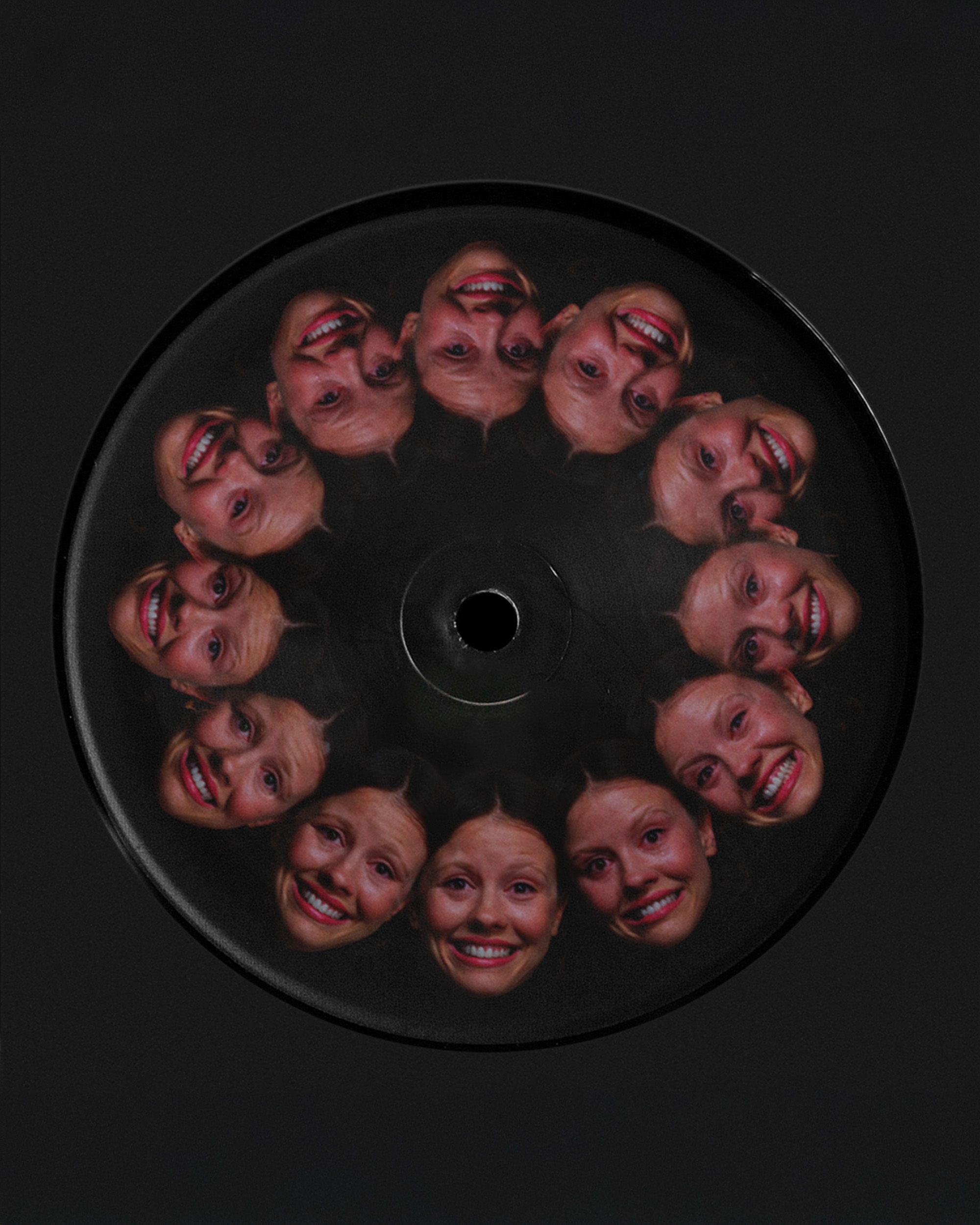 12 repeating smiling faces from "Pearl" ending, encircling center hole on black vinyl