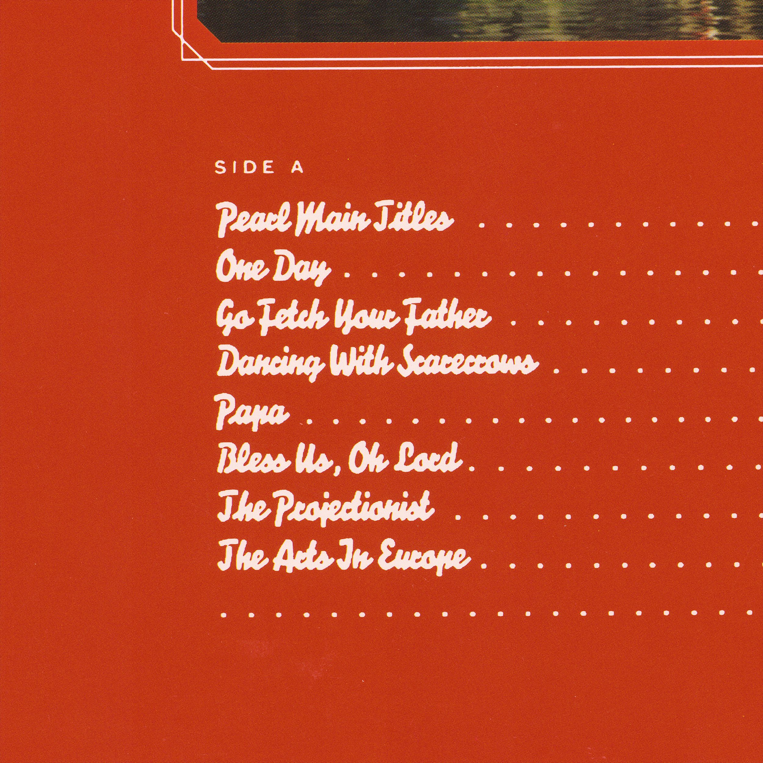 Side A tracklist close-up, ornate photo border detail in white with tracklist below in thick brush script lettering