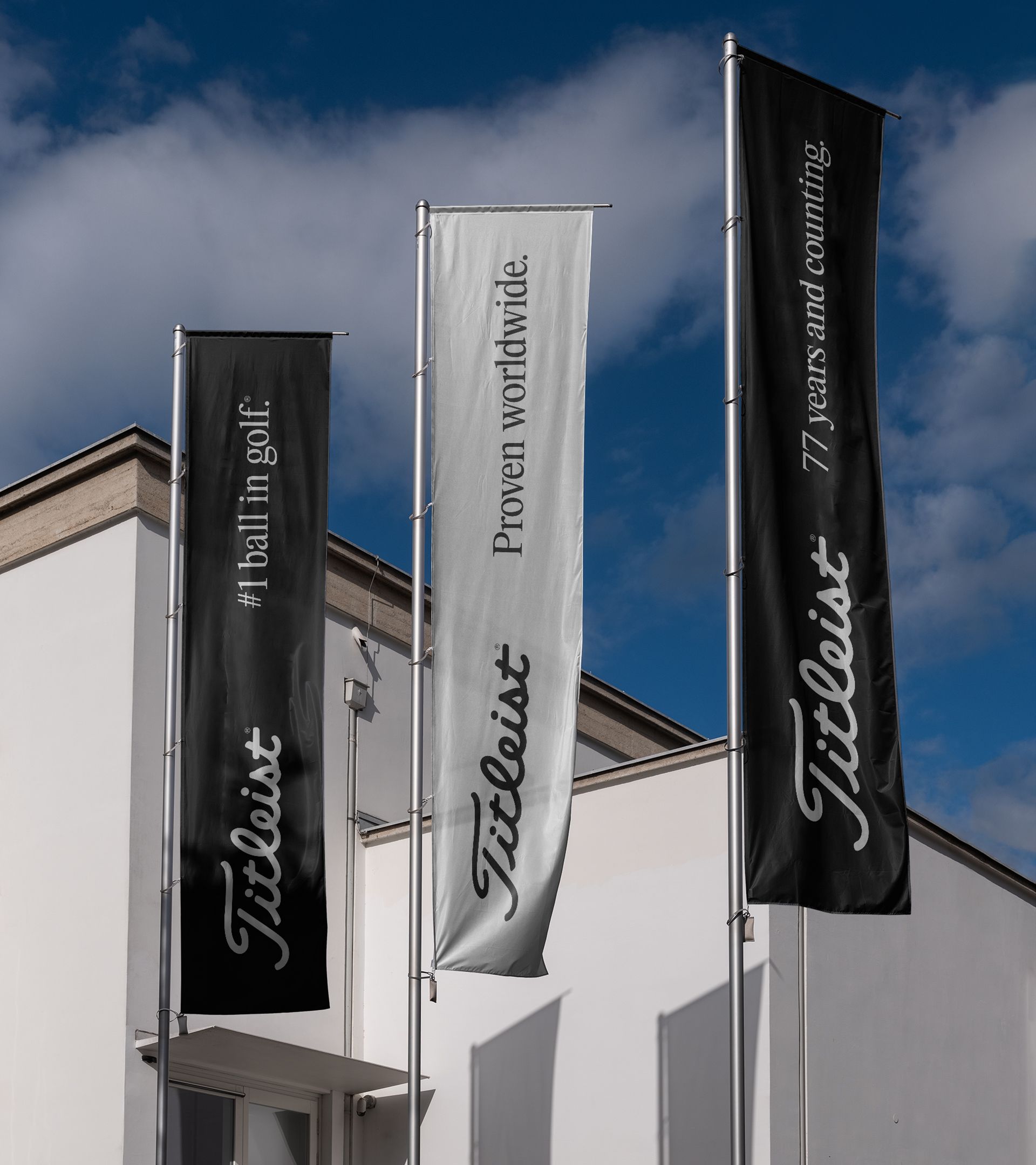 Three vertical banners with the Titleist logo reading “#1 ball in golf.”, “Proven worldwide.” and “77 years and counting.” against a blue sky.
