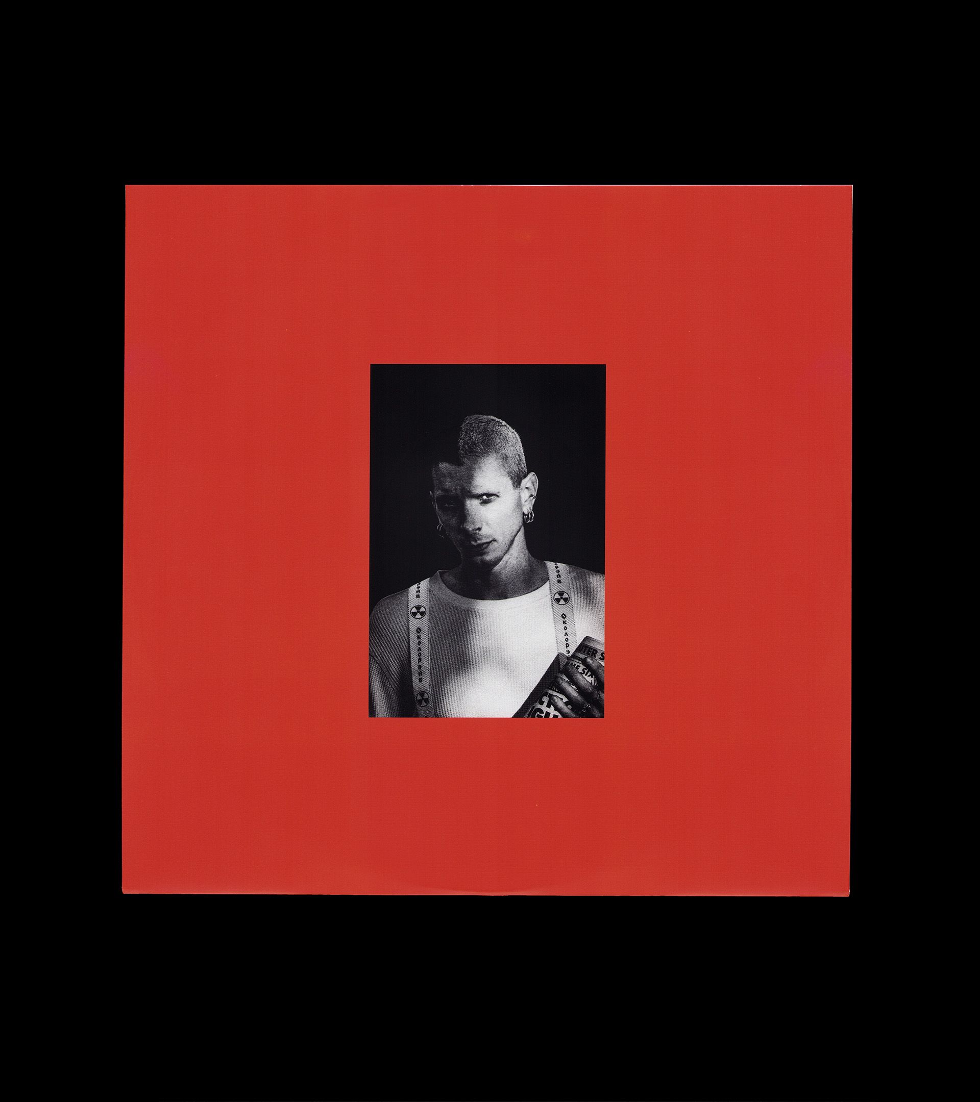 Youth Lagoon RDID vinyl sleeve: red matte fill with B&W portrait inset — Trevor Powers in nuclear-symbol suspenders
